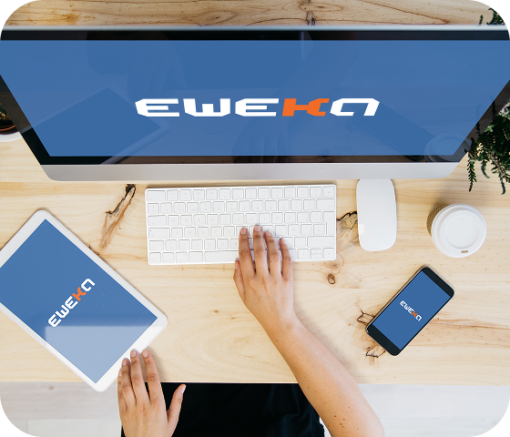 A person is typing on a desktop computer while a tablet and an iPhone are stationed nearby, all open to the Eweka logo, indicating that they are accessing the Internet securely thanks to Eweka’s premium VPN.
