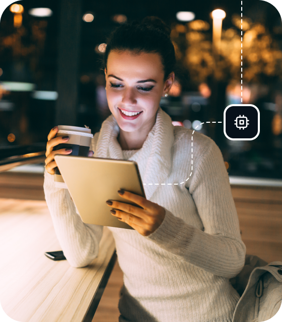 A woman is using a tablet in a cafe and drinking a coffee, activating the Eweka VPN on her device for more powerful security and ongoing protection.