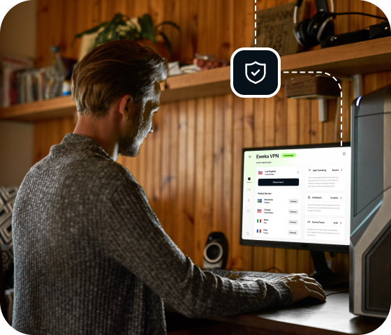 A man sits at a desktop computer, which is connected to Eweka’s unbeatable VPN for Usenet, offering premium security and protection.