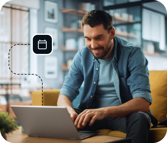 A smiling man sits on a couch in front of an open laptop, connected to Eweka Internet Services, browsing through a huge archive of Usenet posts from the daily Usenet feed.