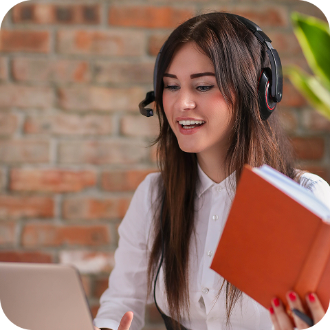 A woman sits in front of a laptop wearing a wired headset, acting as a customer support representative for Eweka users.