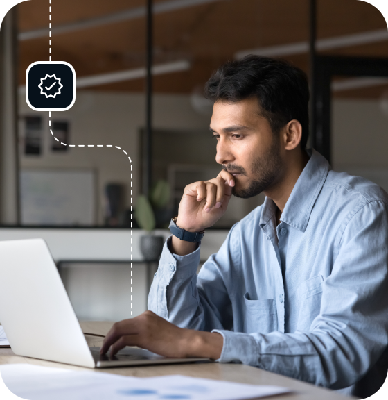A man sits in an office, at a desk, using an open laptop to access Eweka while he successfully searches Usenet newsgroups and articles for fast and easy access to the results he wants.