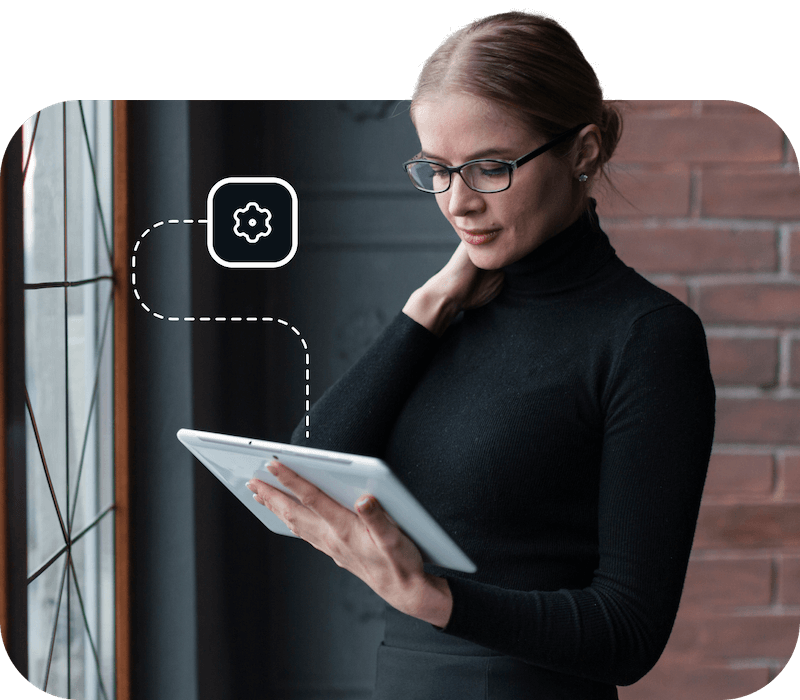 A woman wearing glasses is using a tablet to obtain fast and reliable access to a premium DNS server with the help of Eweka Internet Services.