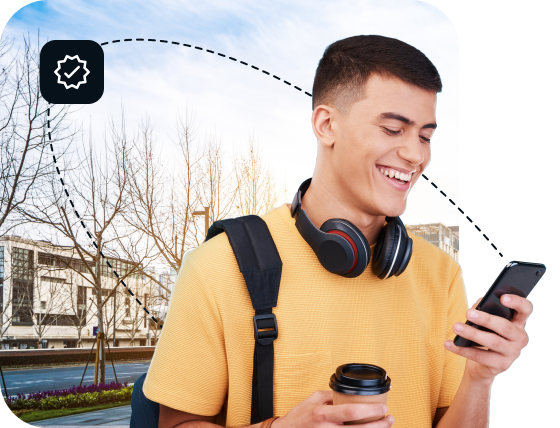 A young man in a yellow shirt is standing outside and using his cell phone to connect to Eweka’s premium VPN.