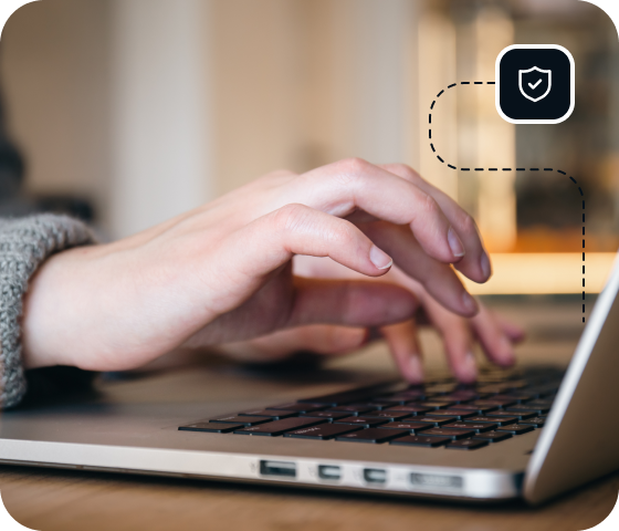 A person is typing on a laptop, connected to Eweka’s secure VPN for Usenet, securely browsing online with more protection. 