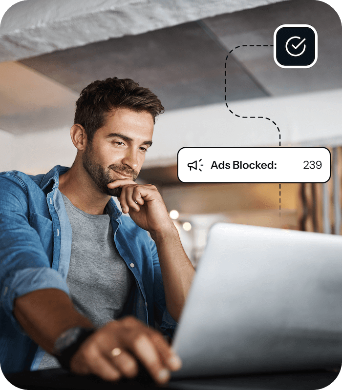 A man sits in front of an open laptop, and a graphic shows that 239 ads have been blocked on his device for added protection against threats like malware and phishing attacks.