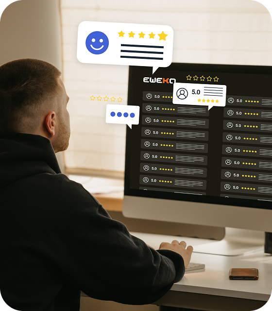 A man in a black jacket is sitting at a desk, using a desktop computer to look at Eweka’s high ratings from other Eweka users.