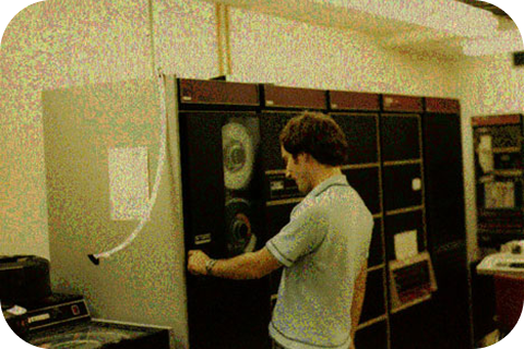 Tom Truscott at Duke University in the late 1970s, making adjustments to a reel-to-reel computer.